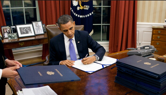 President Obama signing 2015 spending bill